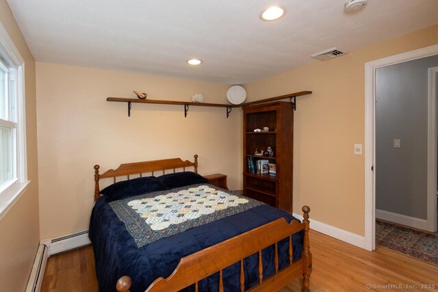 86 Rustic Ln, East Hartford, CT 06118 - bedroom with a baseboard radiator, light wood finished floors, recessed lighting, and baseboards