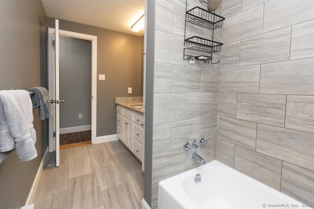 86 Rustic Ln, East Hartford, CT 06118 - full bathroom featuring baseboards, vanity, and  shower combination