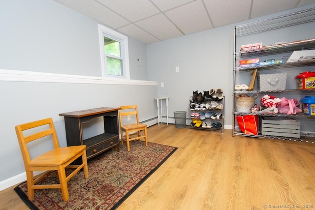 86 Rustic Ln, East Hartford, CT 06118 - living area with a paneled ceiling, wood finished floors, and baseboards