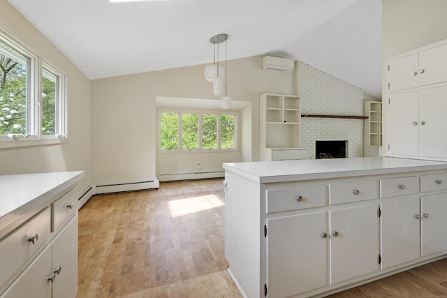102 Colonial Rd, Guilford, CT 06437 - kitchen with a baseboard radiator, plenty of natural light, lofted ceiling, a wall mounted air conditioner, and light countertops