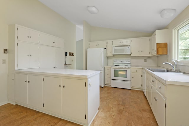 102 Colonial Rd, Guilford, CT 06437 - kitchen with white appliances, vaulted ceiling, light countertops, and a peninsula