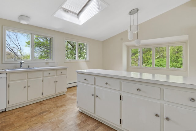 102 Colonial Rd, Guilford, CT 06437 - kitchen with lofted ceiling, light countertops, a baseboard heating unit, healthy amount of natural light, and white cabinets