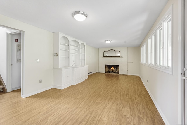 102 Colonial Rd, Guilford, CT 06437 - unfurnished living room with light wood finished floors and a fireplace