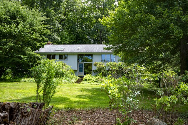 102 Colonial Rd, Guilford, CT 06437 - view of front of home with a front lawn and a chimney