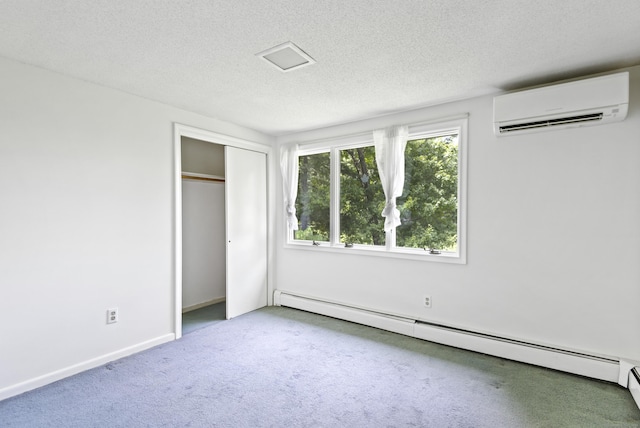 102 Colonial Rd, Guilford, CT 06437 - unfurnished bedroom featuring a wall mounted air conditioner, a baseboard heating unit, carpet flooring, a textured ceiling, and a closet