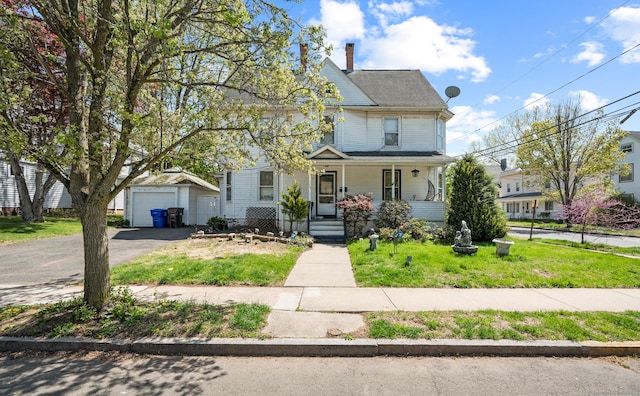 175 Lincoln St, Middletown, CT 06457 - view of front of property featuring covered porch, an outdoor structure, driveway, a front yard, and a chimney