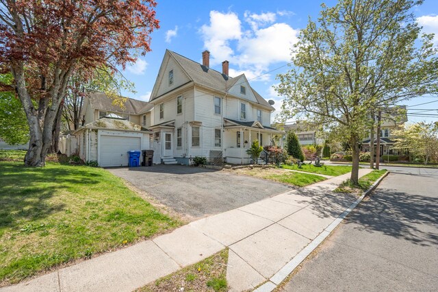 175 Lincoln St, Middletown, CT 06457 - view of front facade featuring a chimney, driveway, a front yard, and an attached garage