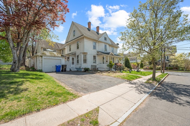 175 Lincoln St, Middletown, CT 06457 - view of front of property with driveway, a front yard, a chimney, and an attached garage