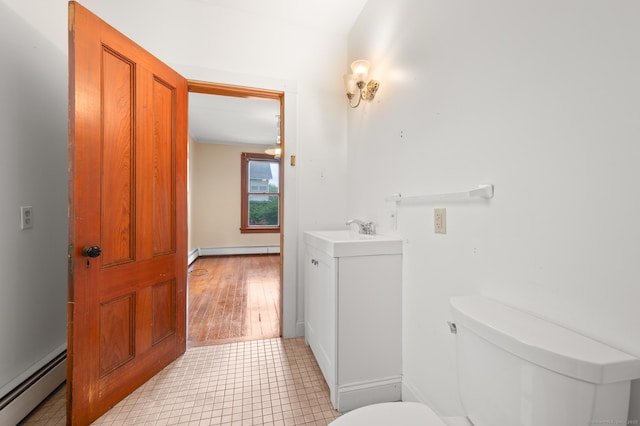 175 Lincoln St, Middletown, CT 06457 - half bathroom featuring baseboard heating, toilet, vanity, and a baseboard radiator