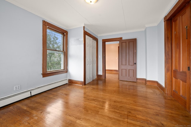 175 Lincoln St, Middletown, CT 06457 - unfurnished bedroom featuring baseboard heating, light wood finished floors, crown molding, baseboards, and a closet