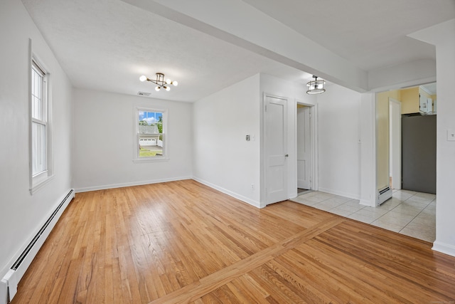 81 Summit St, Southington, CT 06489 - empty room featuring a baseboard radiator, a chandelier, and light wood-style floors