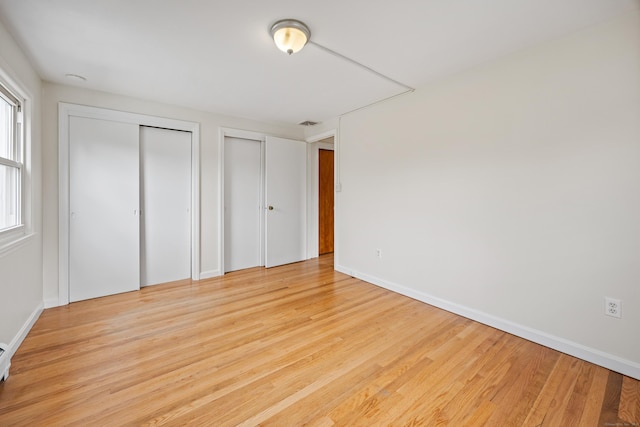 81 Summit St, Southington, CT 06489 - unfurnished bedroom featuring two closets, wood finished floors, and baseboards