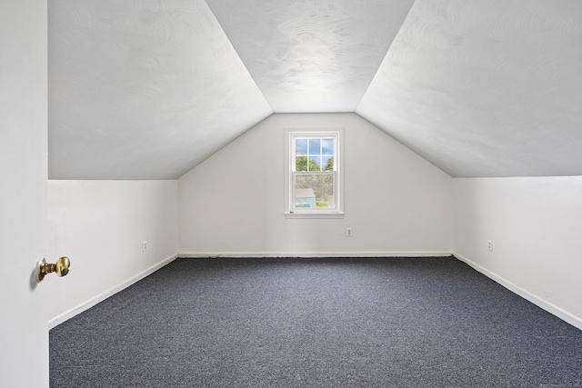 81 Summit St, Southington, CT 06489 - additional living space with vaulted ceiling, dark colored carpet, and baseboards