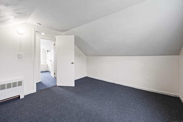 81 Summit St, Southington, CT 06489 - additional living space featuring radiator heating unit, vaulted ceiling, dark colored carpet, and baseboards