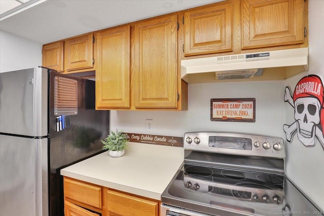 kitchen featuring appliances with stainless steel finishes, under cabinet range hood, and light countertops