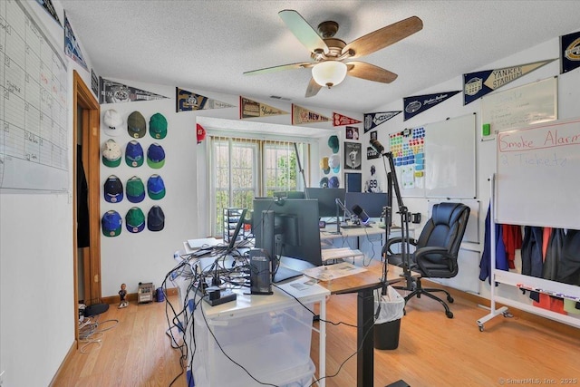 office area featuring a textured ceiling, a ceiling fan, and wood finished floors