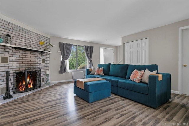 44 Mohawk Trl Unit 44, Guilford, CT 06437 - living area featuring wood finished floors, baseboards, and a brick fireplace