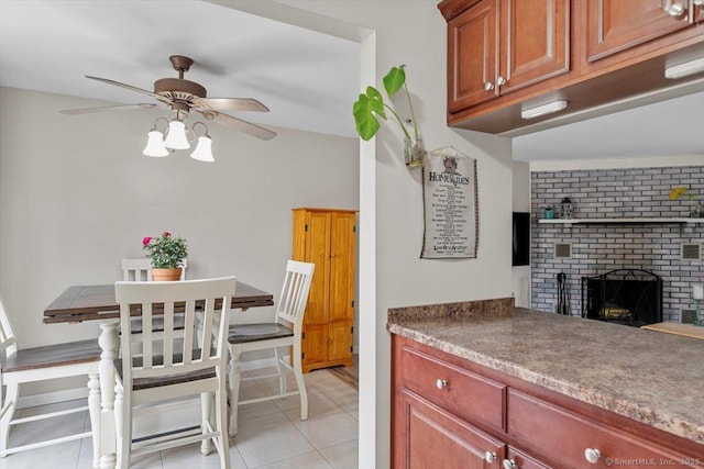 44 Mohawk Trl Unit 44, Guilford, CT 06437 - kitchen featuring light tile patterned floors, a brick fireplace, and ceiling fan