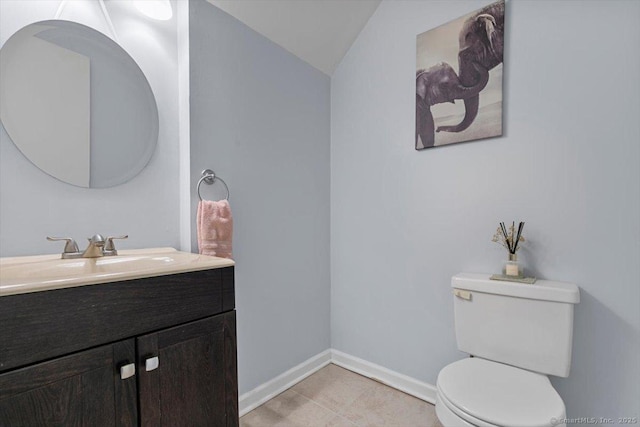 44 Mohawk Trl Unit 44, Guilford, CT 06437 - bathroom with toilet, lofted ceiling, vanity, tile patterned flooring, and baseboards