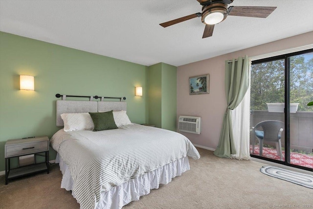 44 Mohawk Trl Unit 44, Guilford, CT 06437 - carpeted bedroom with baseboards, an AC wall unit, ceiling fan, and access to exterior