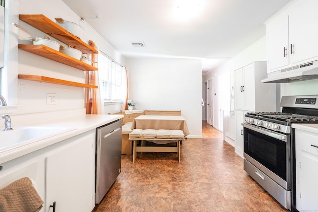 kitchen featuring stainless steel appliances, under cabinet range hood, light floors, open shelves, and white cabinets
