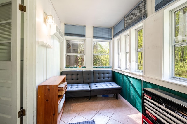 sunroom with healthy amount of natural light and tile patterned flooring