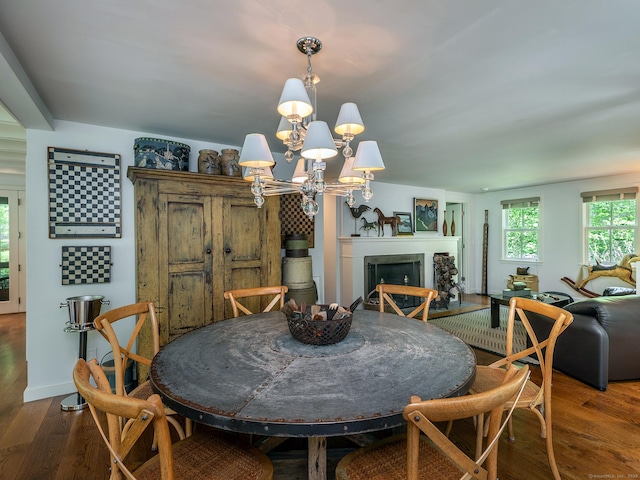 39 Painter Hill Rd, Woodbury, CT 06798 - dining space featuring wood finished floors, a chandelier, and a fireplace