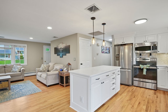 kitchen featuring visible vents, light wood finished floors, light countertops, white cabinets, and appliances with stainless steel finishes