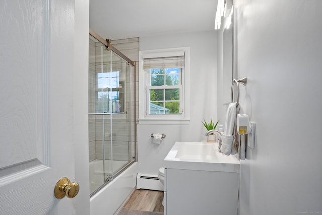 bathroom featuring toilet, enclosed tub / shower combo, wood finished floors, baseboard heating, and vanity