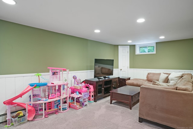 carpeted living area with baseboard heating, wainscoting, and recessed lighting