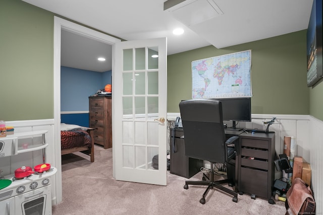 office area with carpet flooring, french doors, and a wainscoted wall