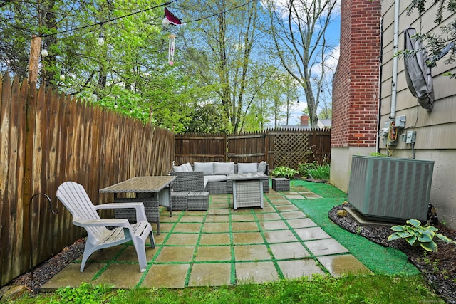 view of patio with an outdoor hangout area, a fenced backyard, and central AC