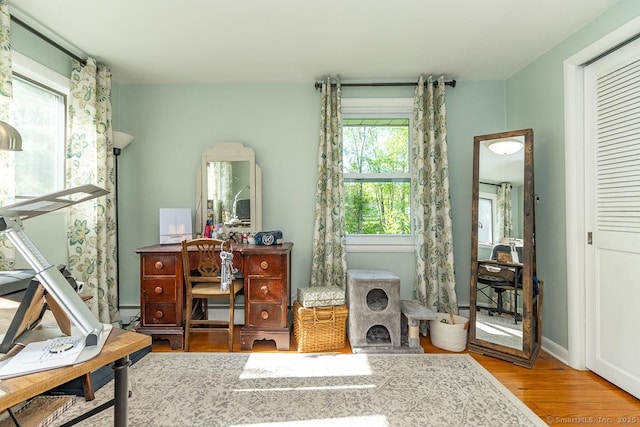 office space with wood finished floors and baseboards