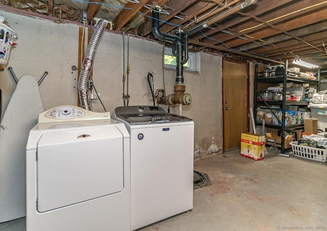 clothes washing area with washer and clothes dryer