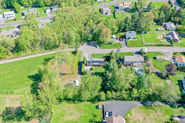 aerial view of property and surrounding area featuring nearby suburban area