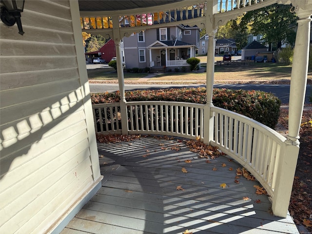 wooden terrace featuring a porch and a residential view