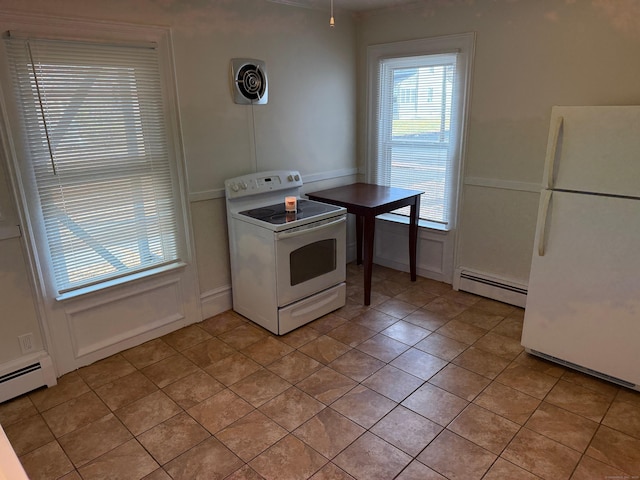 kitchen featuring a baseboard radiator, white appliances, a decorative wall, and visible vents