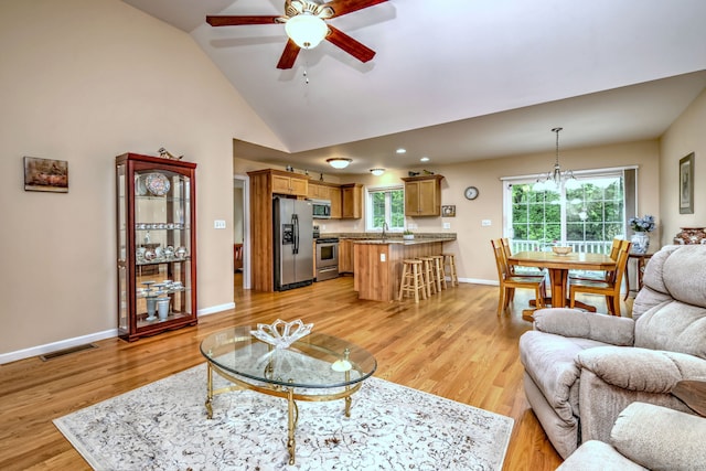 30 Prosperity Ct Unit 25, Southington, CT 06489 - living room featuring ceiling fan, vaulted ceiling, light wood-style flooring, baseboards, and a chandelier
