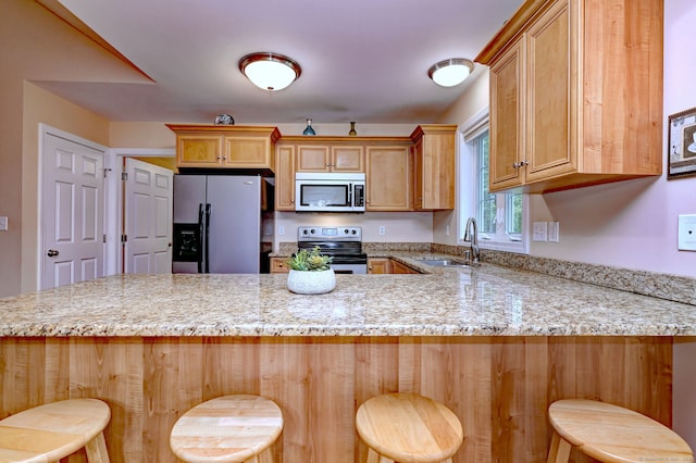 30 Prosperity Ct Unit 25, Southington, CT 06489 - kitchen featuring appliances with stainless steel finishes, a sink, a peninsula, and light stone countertops