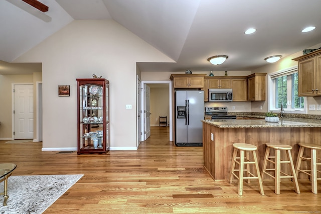 30 Prosperity Ct Unit 25, Southington, CT 06489 - kitchen featuring appliances with stainless steel finishes, light wood-style floors, a kitchen breakfast bar, a peninsula, and light stone countertops