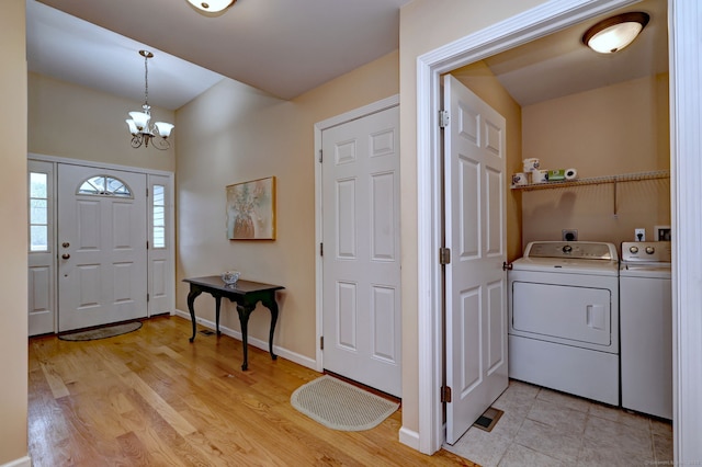 30 Prosperity Ct Unit 25, Southington, CT 06489 - entryway featuring washing machine and dryer, a chandelier, light wood finished floors, and baseboards
