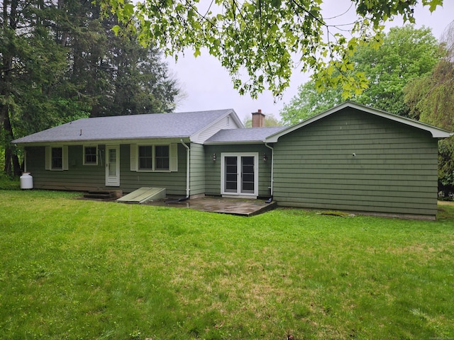 79 Pomfret Rd, Brooklyn, CT 06234 - rear view of house featuring a lawn, a patio area, and a chimney