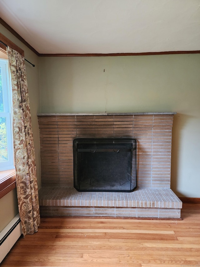 79 Pomfret Rd, Brooklyn, CT 06234 - detailed view of a fireplace, wood finished floors, baseboard heating, ornamental molding, and baseboards