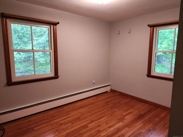 79 Pomfret Rd, Brooklyn, CT 06234 - unfurnished room featuring a baseboard heating unit, wood finished floors, and baseboards