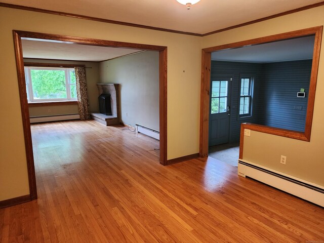 79 Pomfret Rd, Brooklyn, CT 06234 - empty room with a baseboard heating unit, light wood-style flooring, and ornamental molding