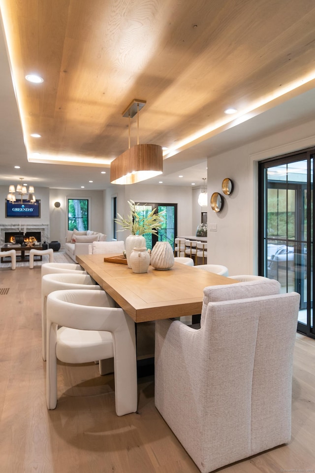 26 Hitchcock Rd, Westport, CT 06880 - dining room with wood ceiling, light wood finished floors, recessed lighting, a warm lit fireplace, and a tray ceiling