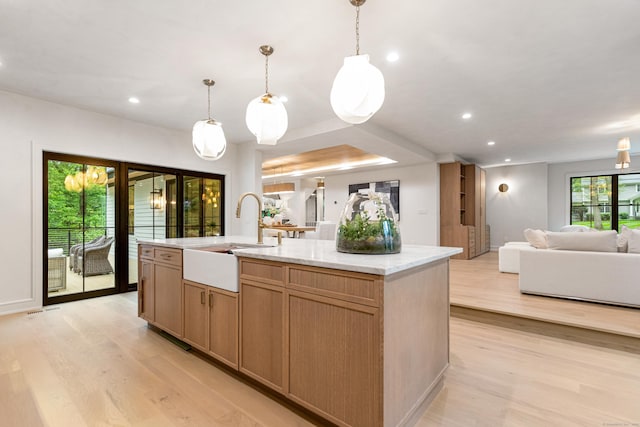26 Hitchcock Rd, Westport, CT 06880 - kitchen with a sink, open floor plan, light wood-style flooring, a center island with sink, and recessed lighting