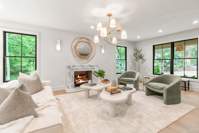 26 Hitchcock Rd, Westport, CT 06880 - living area featuring plenty of natural light, light wood-type flooring, recessed lighting, a premium fireplace, and a chandelier
