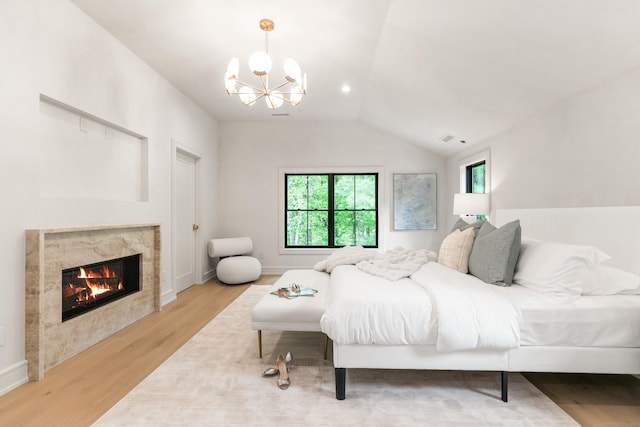 26 Hitchcock Rd, Westport, CT 06880 - bedroom featuring wood finished floors, a chandelier, lofted ceiling, and a premium fireplace
