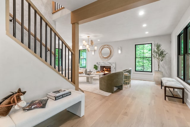 26 Hitchcock Rd, Westport, CT 06880 - living area with wood finished floors, recessed lighting, stairs, a high end fireplace, and a chandelier